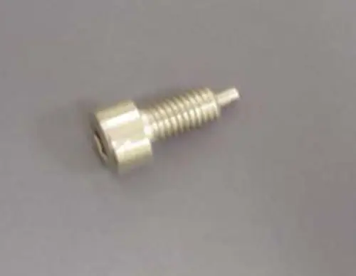 Stanzschraube von Remeha, metallisch, mit einem gewundenen Körper und einem angepassten Kopf, auf grauem Hintergrund liegend.